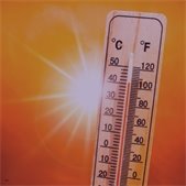 photo of thermometer indicating high temperatures and orange background with sun