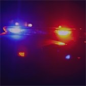 photo of police squad lights flashing in the night