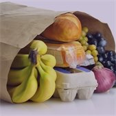 Paper grocery bag filled with bananas, bread, eggs, grapes, cheese, and an onion