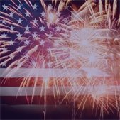 photo of fireworks in front of US flag