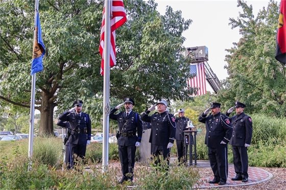 photo of honor guard saluting the american flag during the ceremony