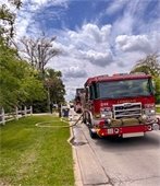 photo for red lombard fire engine parked on street with yellow hoses out