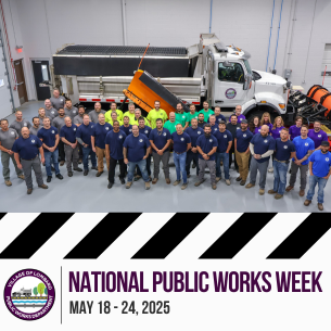 photo of public works staff in front of snow plow
