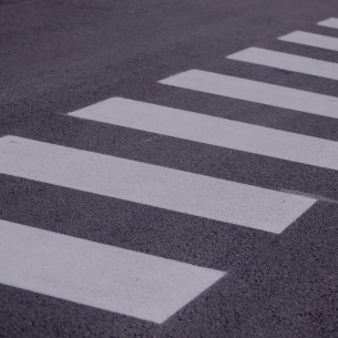 Close-up of a painted crosswalk on asphalt