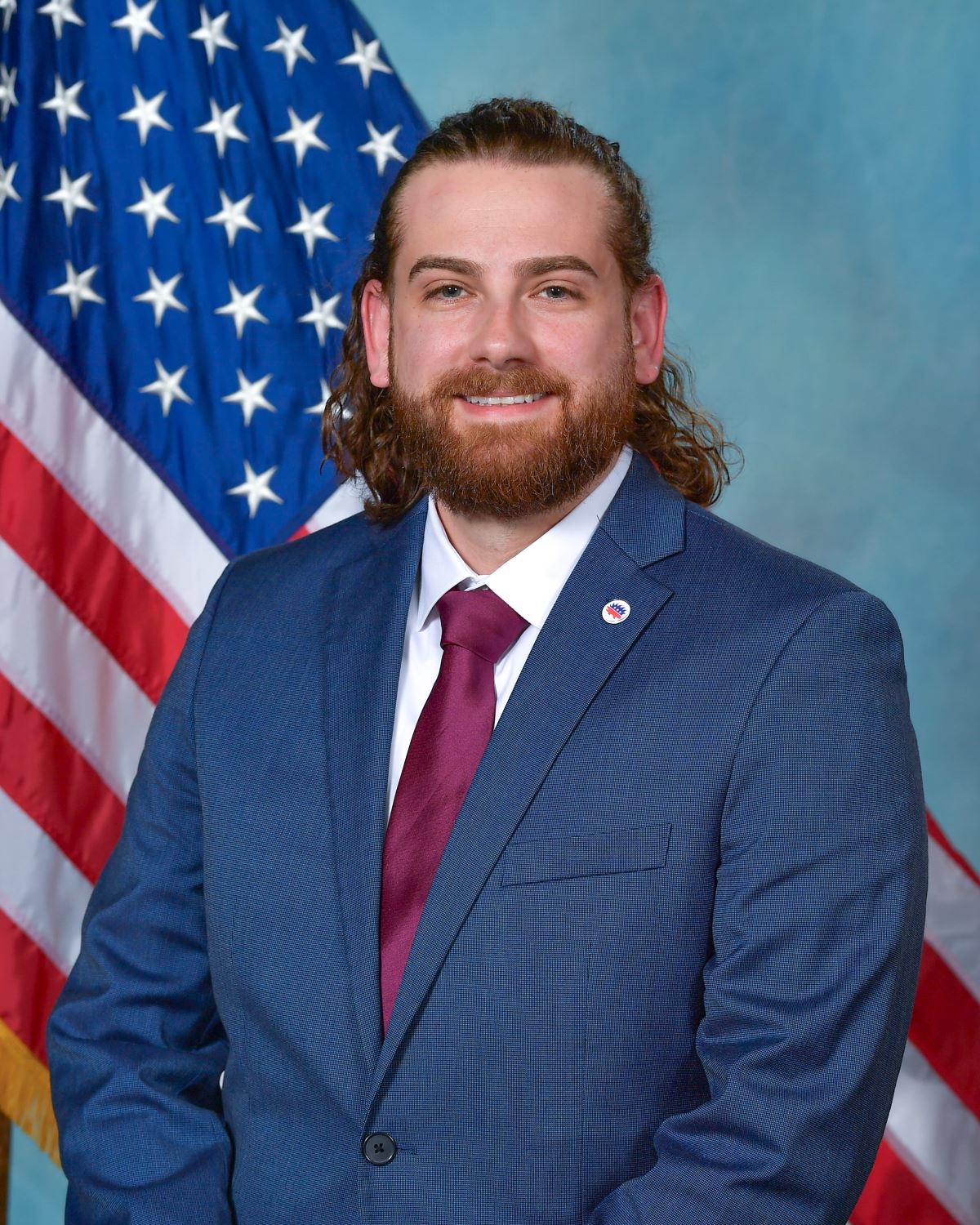 Headshot of Trustee Dan Militello with US flag in background